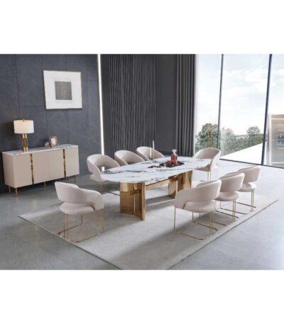 Oval white marble-look dining table with gold column base and beige upholstered chairs