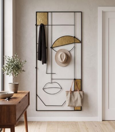 Black metal abstract face wall art with textured gold-glass panels and coat hooks — view 2