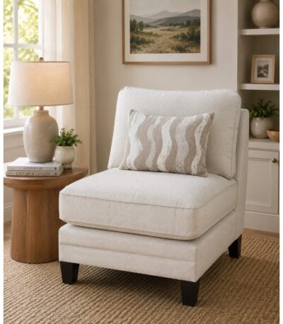 Warm ivory armless fabric accent chair with taupe wave-patterned scatter cushion