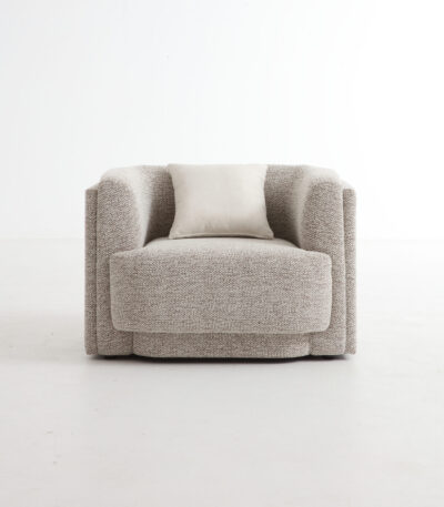 Warm taupe boucle fabric sofa chair with curved barrel back and ivory scatter cushion