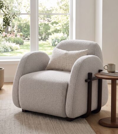 Warm grey bouclé sofa chair with exposed dark walnut wood frame detail