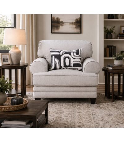 Warm dove grey fabric sofa chair with rolled arms and geometric scatter cushion