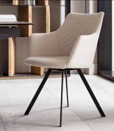 Warm beige fabric swivel chair with diamond-quilted back and black metal legs