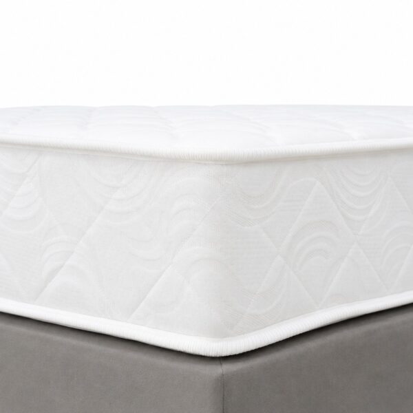 White knitted-cover Bonnell spring mattress corner detail on grey bed base