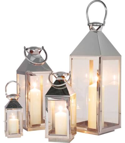 Set of four silver stainless steel glass lanterns with pyramid tops and candles