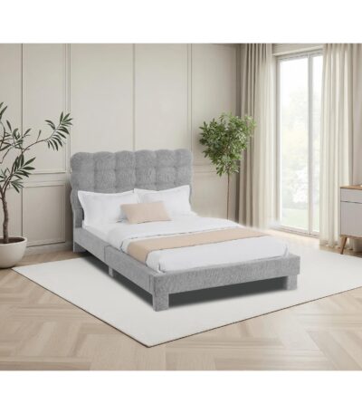 Grey fabric single bed with biscuit-tufted curved headboard and wooden slat base