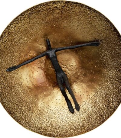 Round brass-finish aluminium wall sculpture with black figurative silhouette