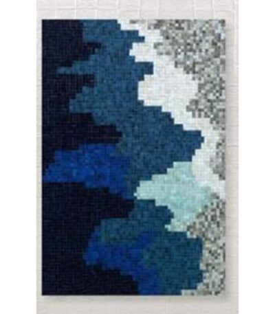 Wool patchwork area rug in indigo blue and stone tones with abstract wave pattern