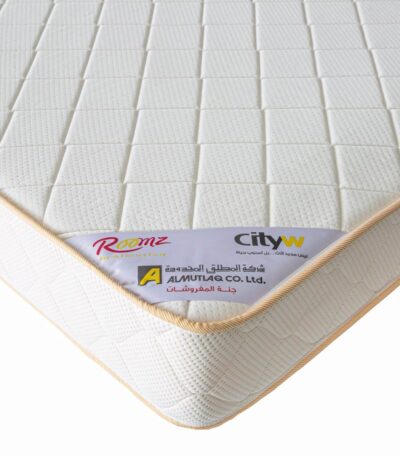 White quilted spring mattress with knitted cover and piped edge detail