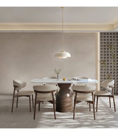 White sintered stone dining table with walnut pedestal base and six ivory upholstered chairs