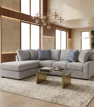 Light grey chenille sectional sofa with chaise and striped scatter cushions
