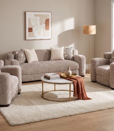 Warm taupe chenille sofa set with rolled bolster arms and patterned scatter cushions — full set